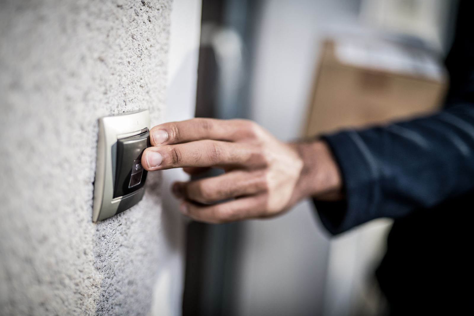 Process server ringing a doorbell with papers in hand